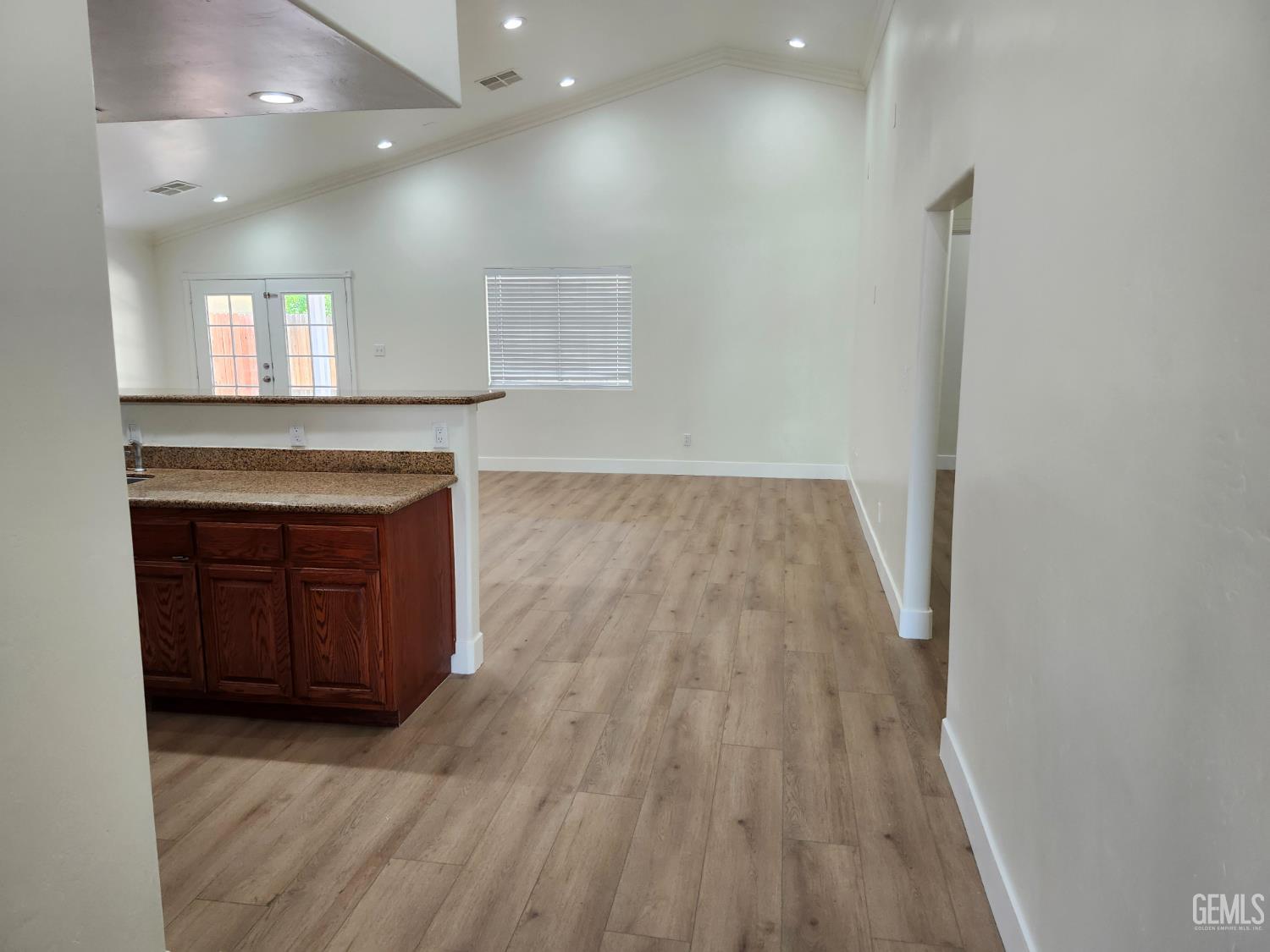 Undisclosed Address Delano, CA 93215 - Photo 4 of 33 an empty room with wooden floor and windows