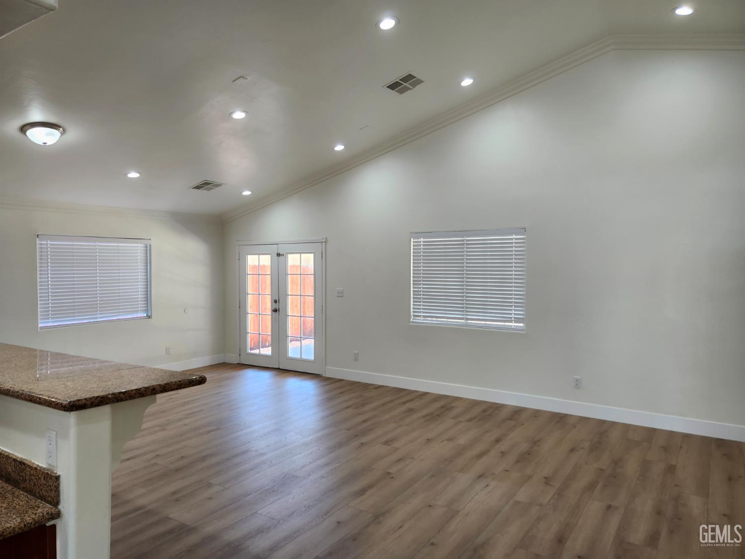 Undisclosed Address Delano, CA 93215 - Photo 5 of 33 an empty room with wooden floor and windows