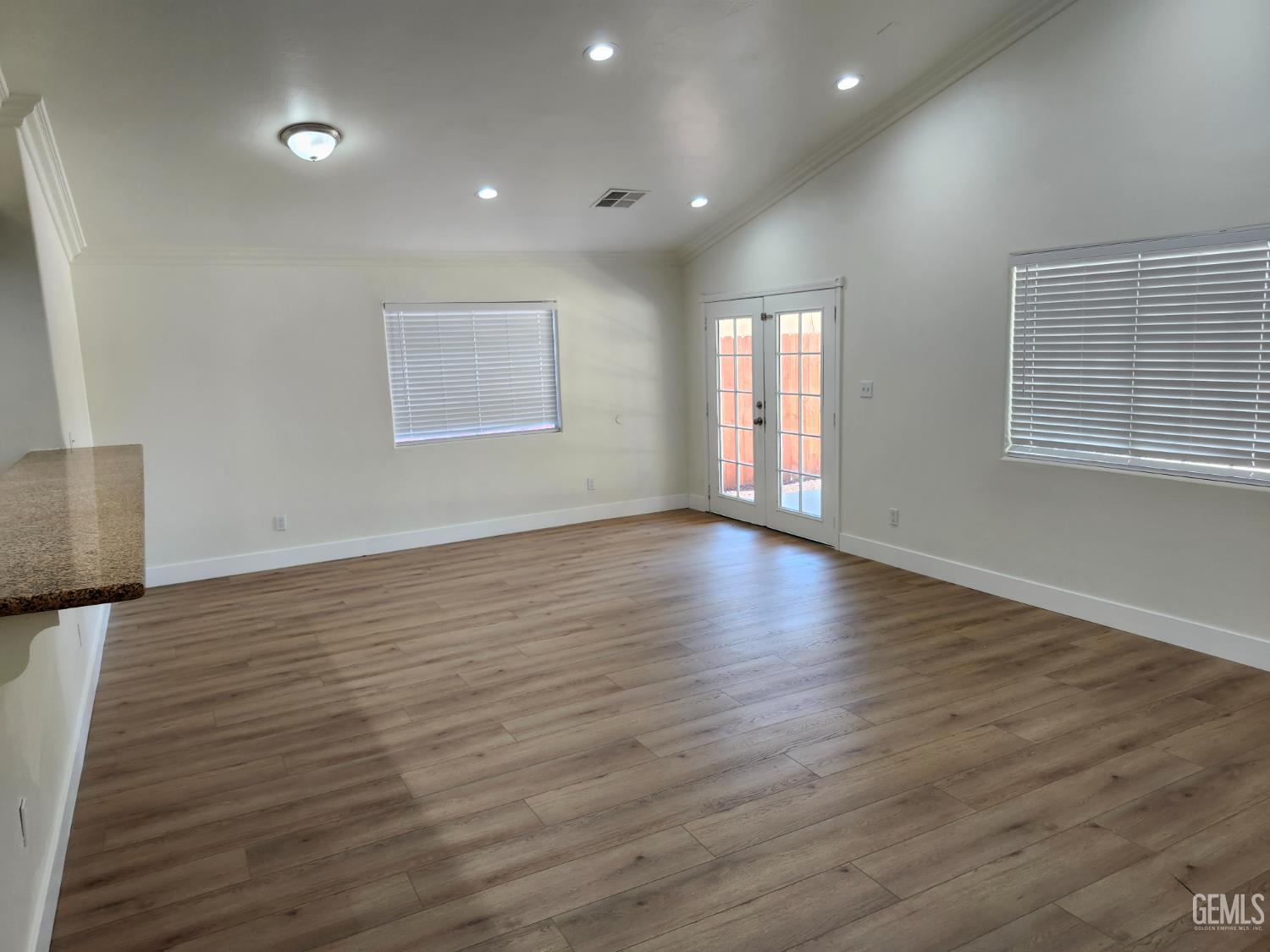 Undisclosed Address Delano, CA 93215 - Photo 7 of 33 an empty room with wooden floor and windows