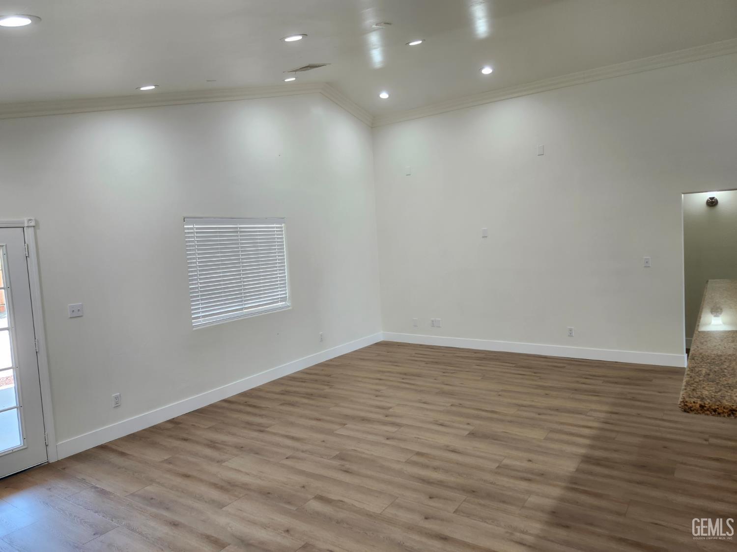 Undisclosed Address Delano, CA 93215 - Photo 8 of 33 an empty room with wooden floor and windows