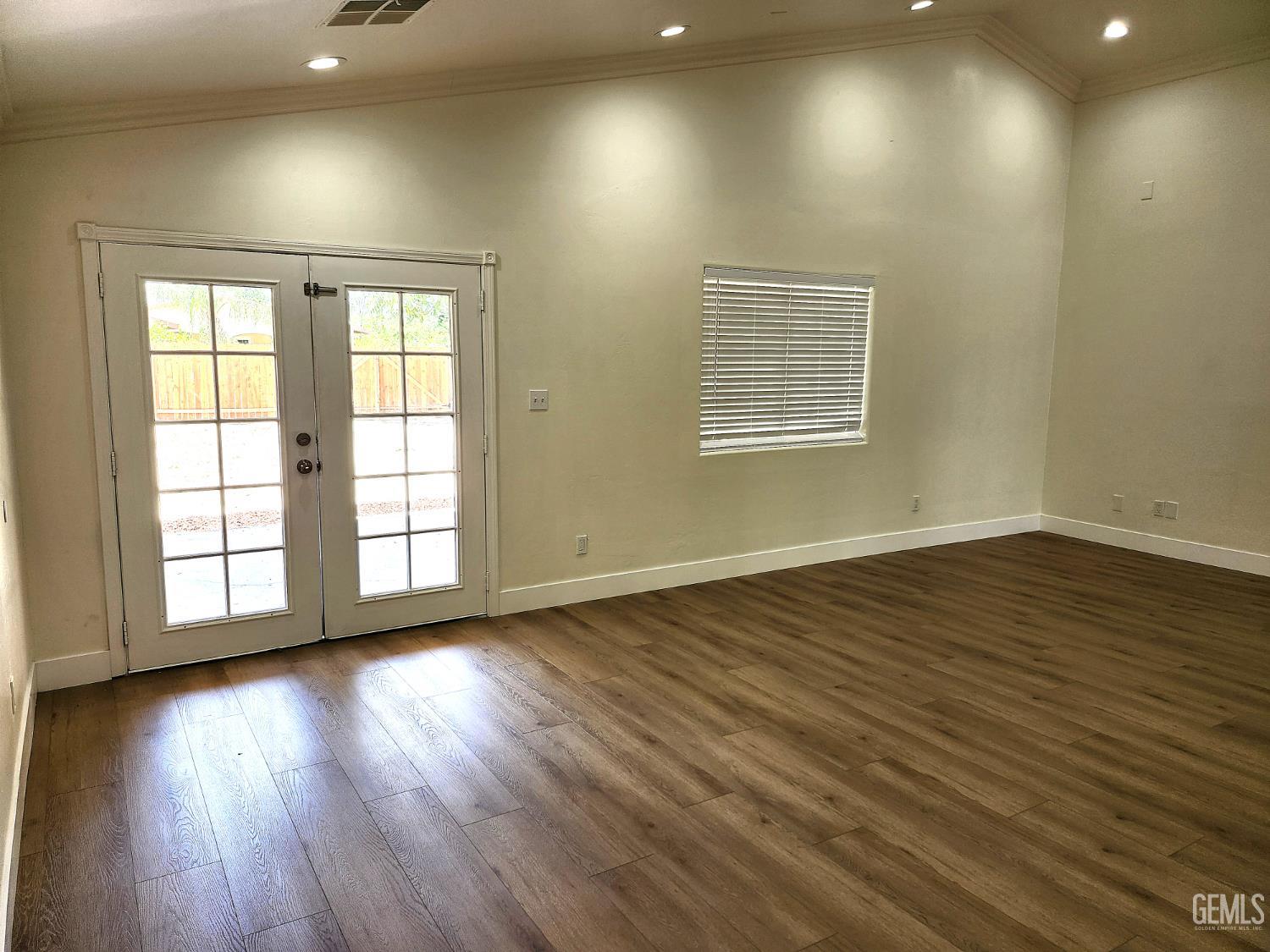 Undisclosed Address Delano, CA 93215 - Photo 9 of 33 an empty room with wooden floor and windows
