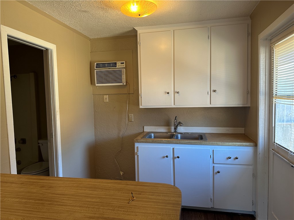 4705 Wooldridge Road Corpus Christi, TX 78413 - Photo 14 of 16 a kitchen with a sink and cabinets