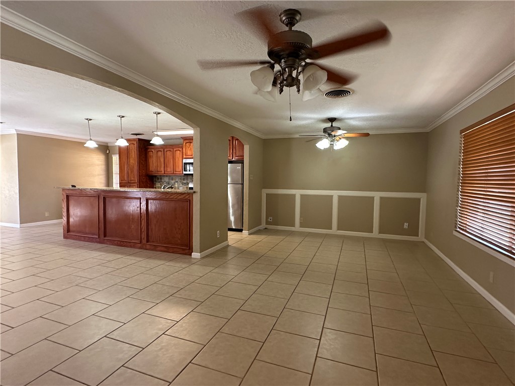 4705 Wooldridge Road Corpus Christi, TX 78413 - Photo 4 of 16 a view of a livingroom with a chandelier furniture and windows