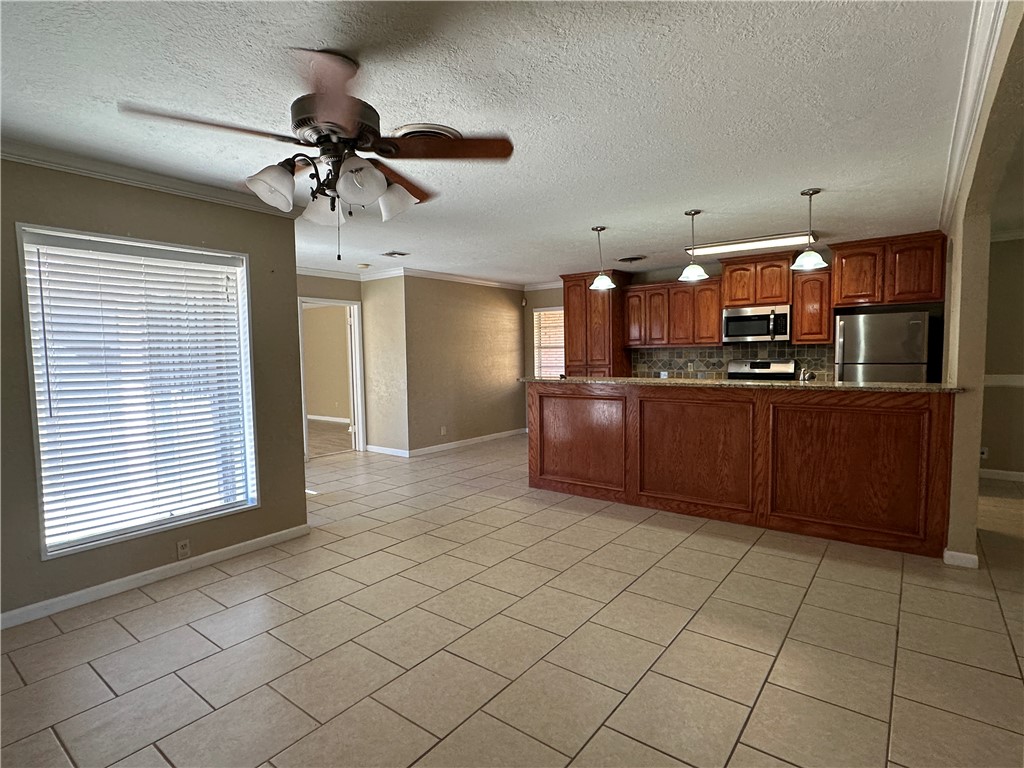 4705 Wooldridge Road Corpus Christi, TX 78413 - Photo 5 of 16 a kitchen with stainless steel appliances granite countertop a refrigerator and a sink