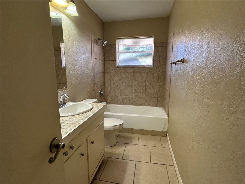 4705 Wooldridge Road Corpus Christi, TX 78413 - Photo 6 of 16 a bathroom with a granite countertop sink toilet and shower