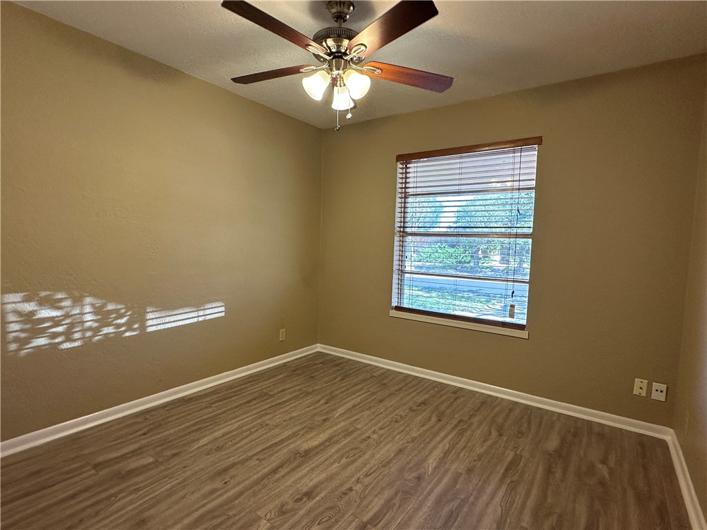 4705 Wooldridge Road Corpus Christi, TX 78413 - Photo 7 of 16 a view of empty room with wooden floor and fan