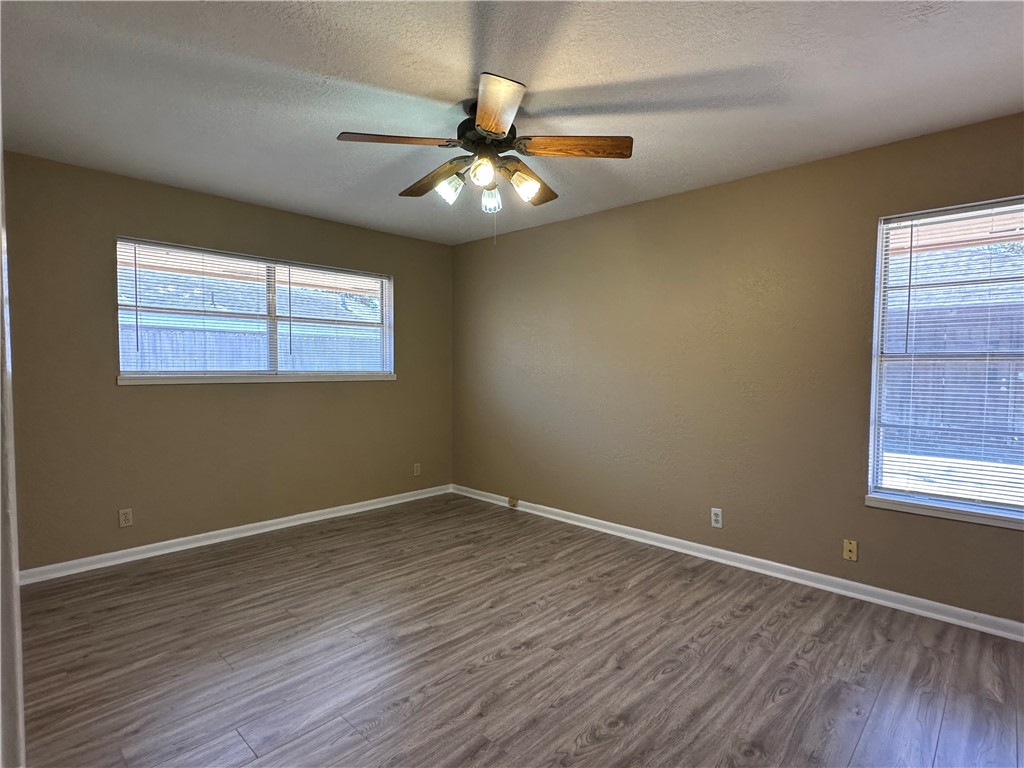 4705 Wooldridge Road Corpus Christi, TX 78413 - Photo 8 of 16 a view of an empty room with wooden floor and a window