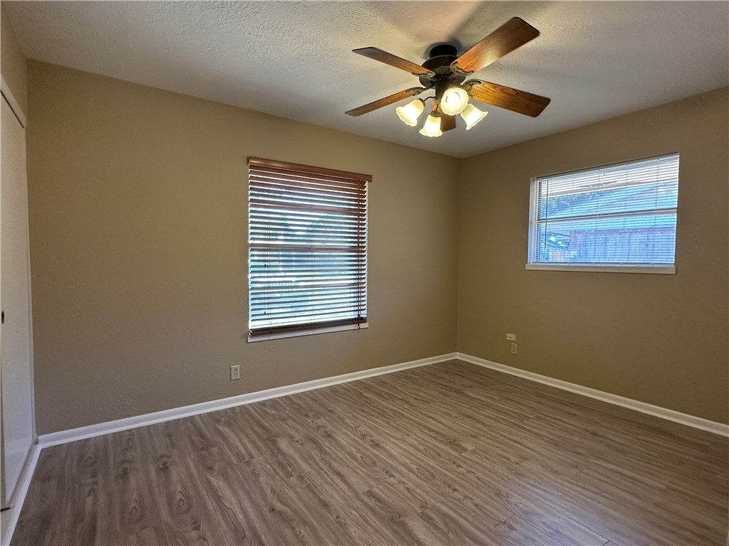 4705 Wooldridge Road Corpus Christi, TX 78413 - Photo 9 of 16 a view of an empty room with wooden floor and a window