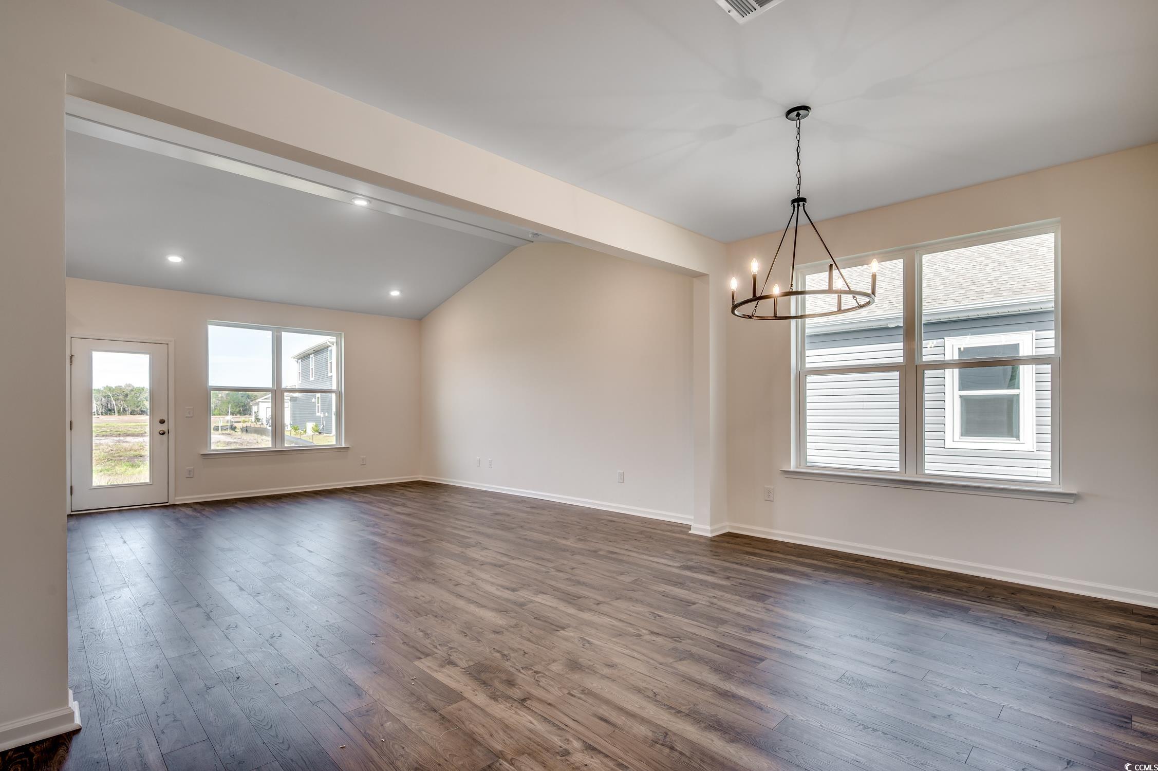 4004 Braid Court Myrtle Beach, SC 29588 - Photo 3 of 24 Unfurnished dining area with dark wood-type flooring and a chandelier