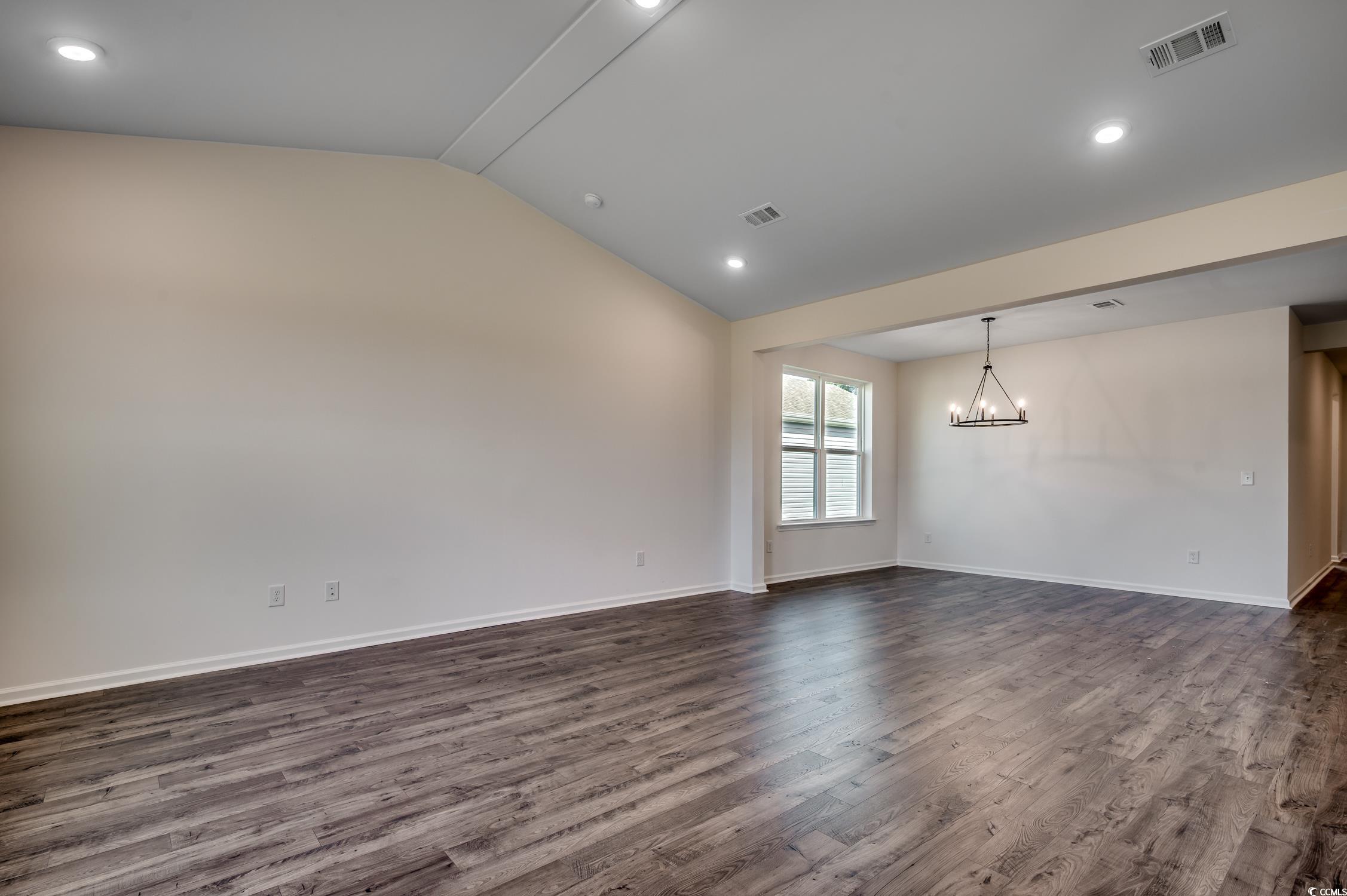 4004 Braid Court Myrtle Beach, SC 29588 - Photo 4 of 24 Spare room featuring lofted ceiling, dark wood-style flooring, recessed lighting, and a chandelier