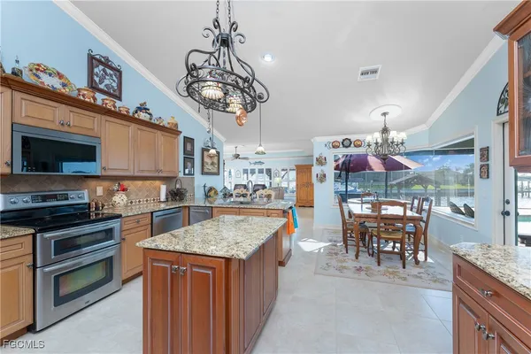 a kitchen with stainless steel appliances granite countertop a sink and cabinets