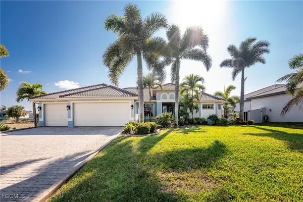 a view of a house with a swimming pool and a yard