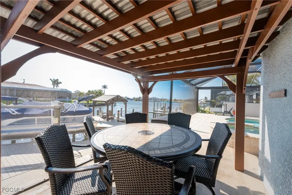 a view of a patio with a table and chairs
