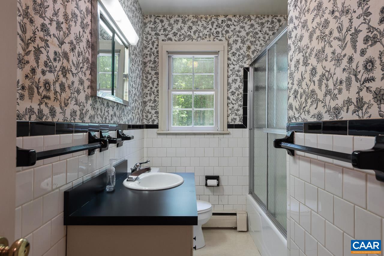 995 Shadwell Road Keswick, VA 22947 - Photo 16 of 23 a bathroom with a sink and a mirror