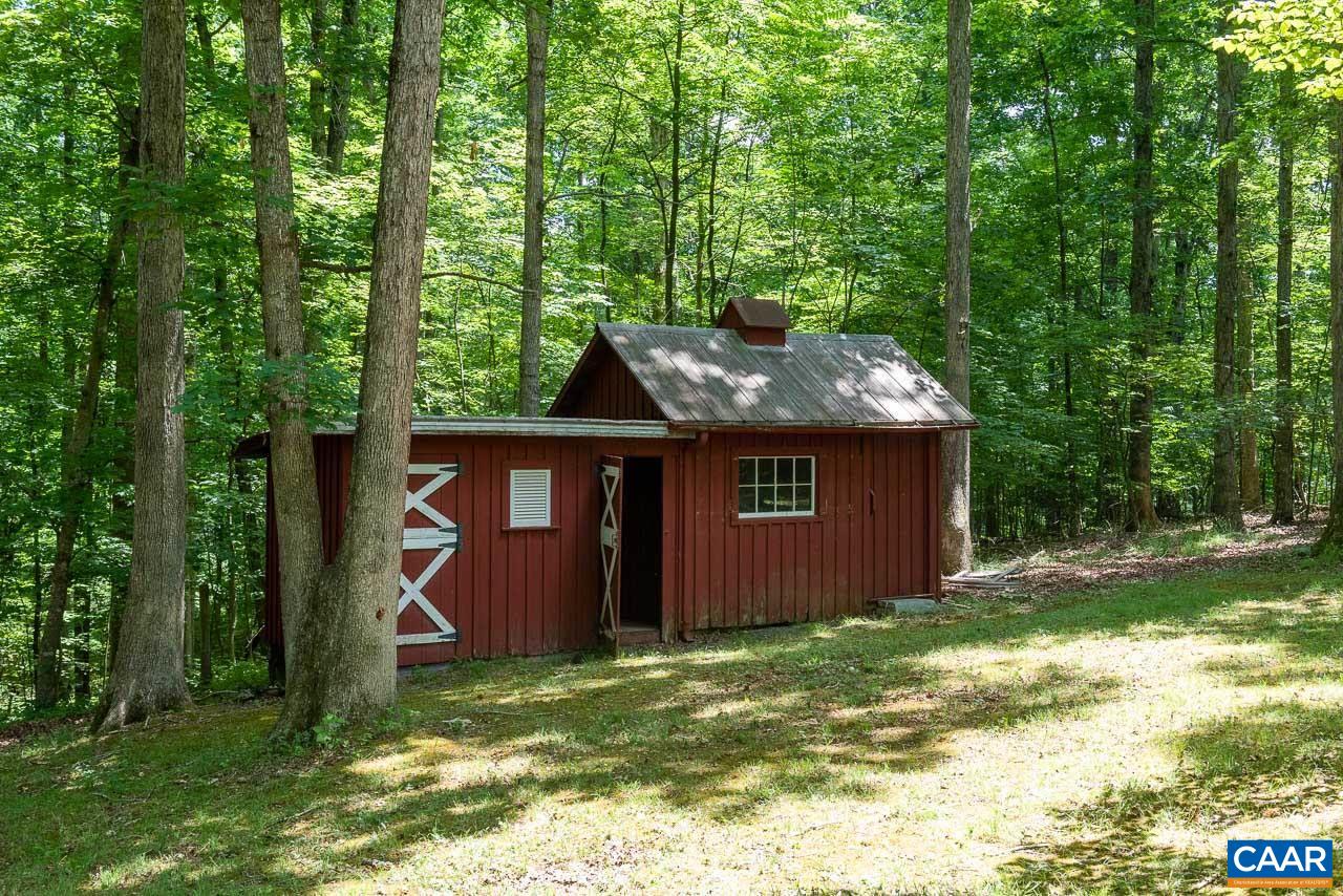 995 Shadwell Road Keswick, VA 22947 - Photo 19 of 23 a backyard of a house with a garden and deck