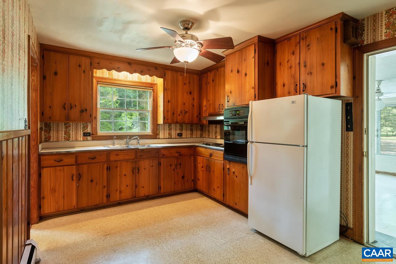 995 Shadwell Road Keswick, VA 22947 - Photo 7 of 23 a kitchen with refrigerator a sink cabinets and a large window