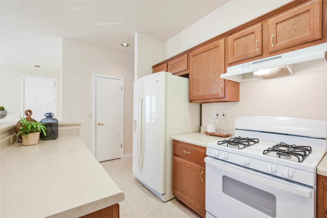 112 Anemone Way Georgetown, TX 78633 - Photo 15 of 40 a kitchen with stainless steel appliances a stove a refrigerator and cabinets