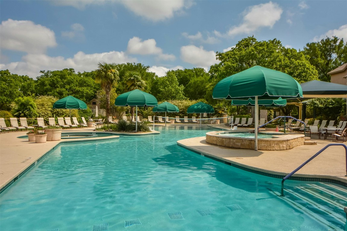 112 Anemone Way Georgetown, TX 78633 - Photo 36 of 40 a view of a swimming pool with lawn chairs under an umbrella