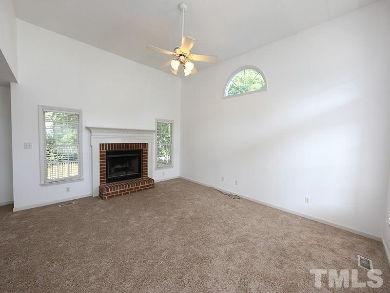 5225 Sutter Way Raleigh, NC 27613 - Photo 2 of 12 an empty room with windows and fireplace