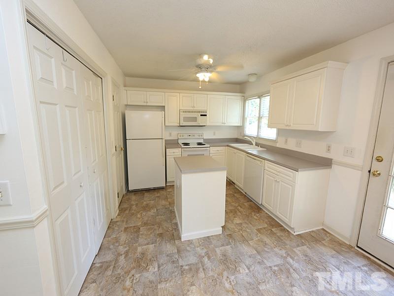 5225 Sutter Way Raleigh, NC 27613 - Photo 4 of 12 a kitchen with a refrigerator sink and cabinets