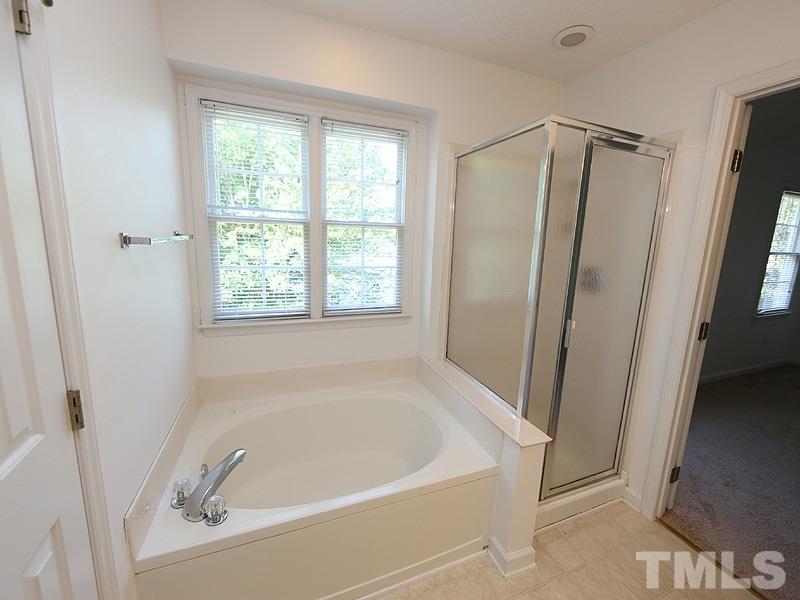 5225 Sutter Way Raleigh, NC 27613 - Photo 7 of 12 a white bath tub sitting next to a shower