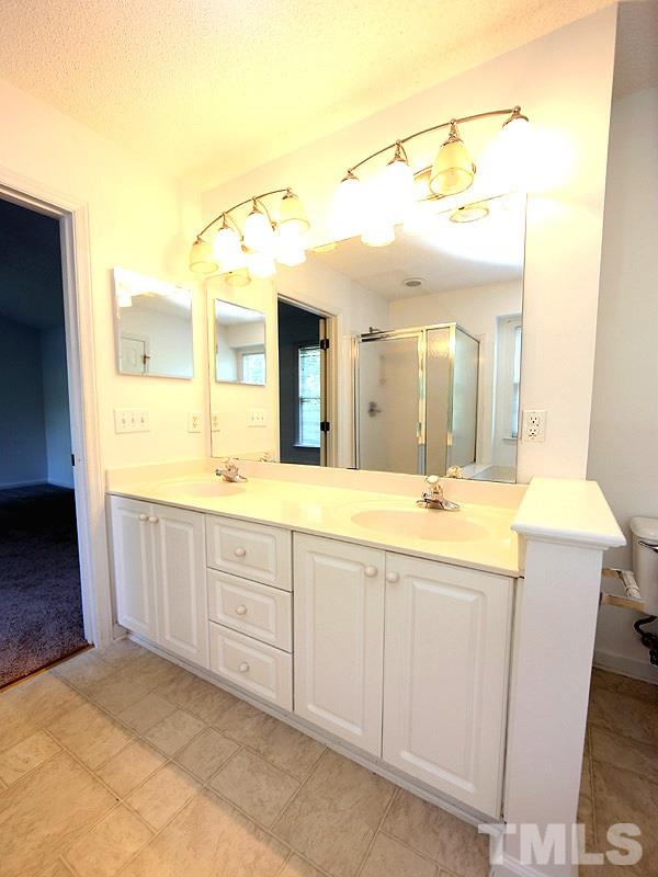 5225 Sutter Way Raleigh, NC 27613 - Photo 8 of 12 a spacious bathroom with a granite countertop sink mirror and a