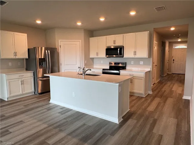 a large kitchen with stainless steel appliances