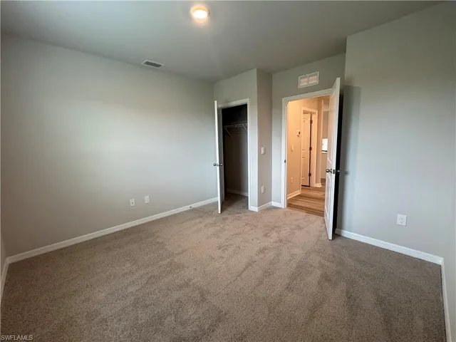 a view of an empty room and closet area