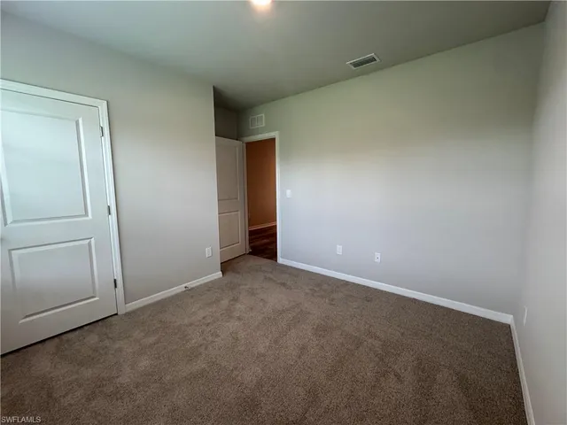 an empty room with closet area