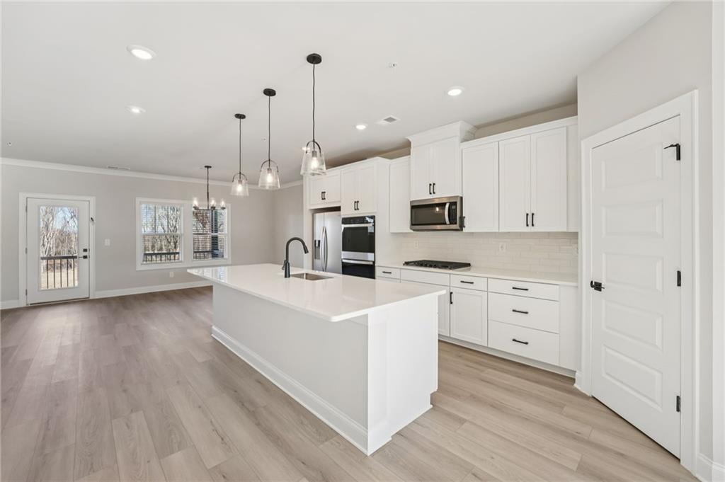 6440 Pinin Place Cumming, GA 30041 - Photo 21 of 52 a large white kitchen with cabinets a sink and appliances