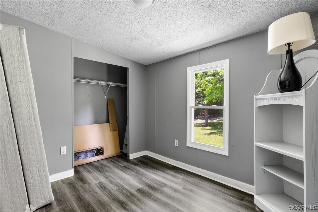 3549 Cedar Plains Road Sandy Hook, VA 23153 - Photo 14 of 26 a view of an empty room with window and wooden floor