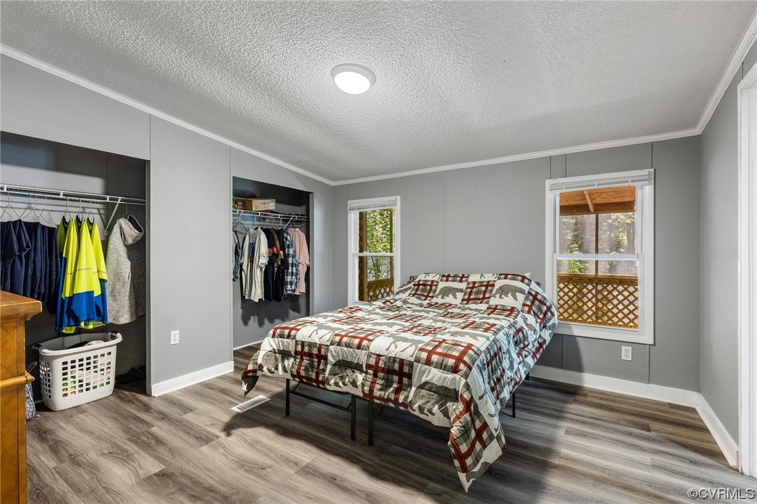 3549 Cedar Plains Road Sandy Hook, VA 23153 - Photo 16 of 26 a bedroom with a bed and wooden floor