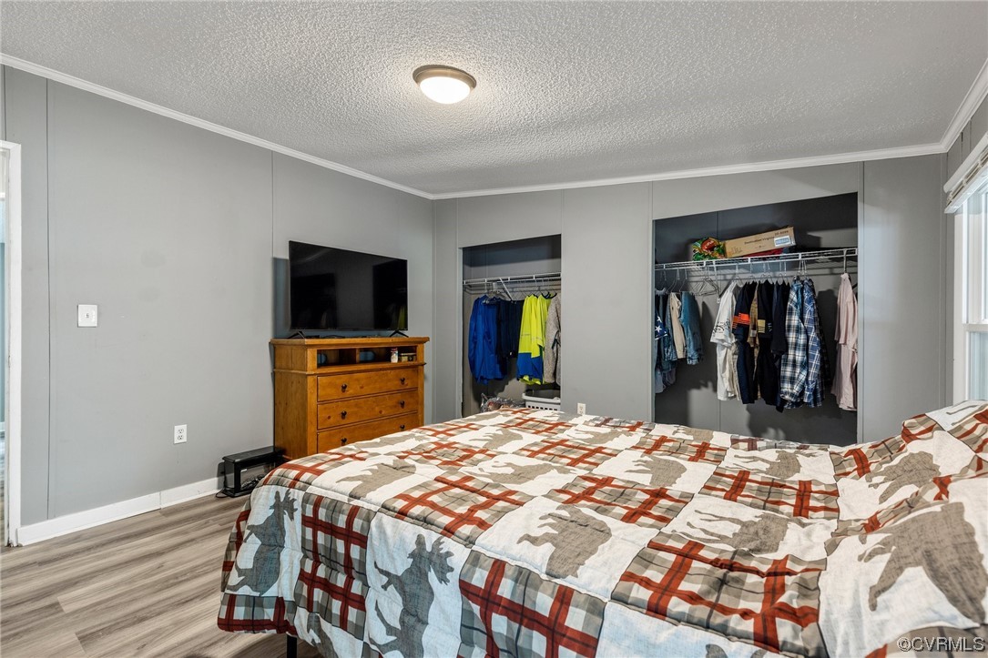 3549 Cedar Plains Road Sandy Hook, VA 23153 - Photo 18 of 26 a large bedroom with a bed and a flat screen tv