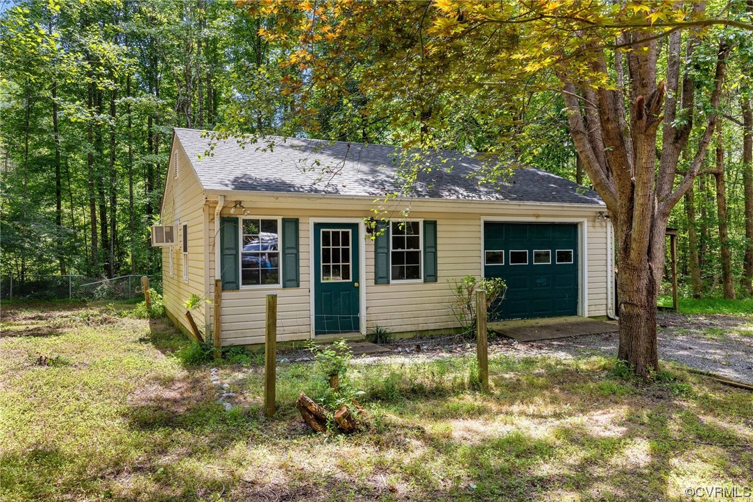 3549 Cedar Plains Road Sandy Hook, VA 23153 - Photo 26 of 26 a view of a house with backyard and a large tree