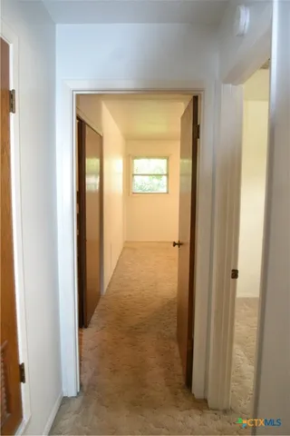 a view of a hallway with a door