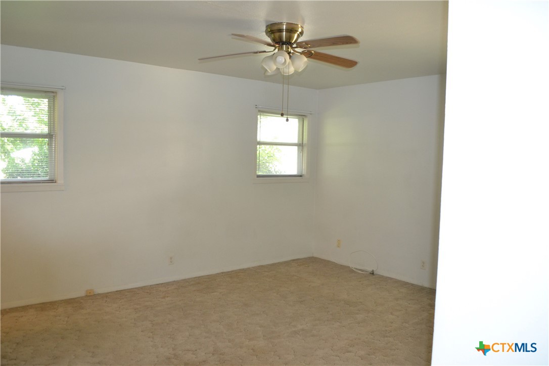2202 South 53rd Street Temple, TX 76504 - Photo 18 of 27 an empty room with a window and a fan