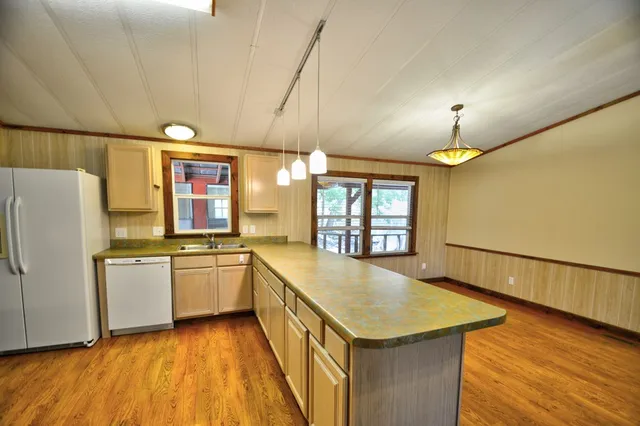 a kitchen with stainless steel appliances a stove a sink and a refrigerator