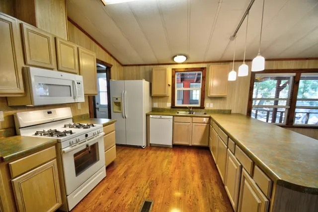 a view of a room with wooden floor and window