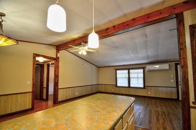 a view of a kitchen with a sink and wooden floor
