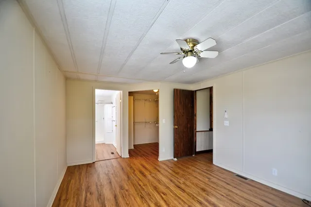 a view of a closet with wooden floor