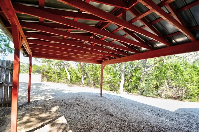 a backyard of a house with table and chairs