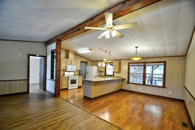 a view of a living room with furniture and wooden floor