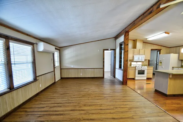 a view of kitchen with stainless steel appliances granite countertop a stove a sink dishwasher and a microwave oven on the wall