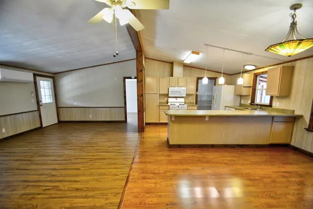a view of a kitchen with a sink dishwasher and a large window