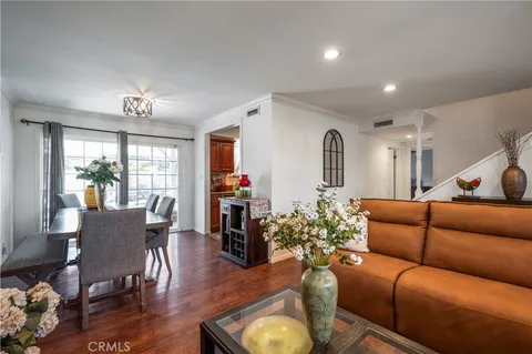 a living room with furniture ceiling fan and a window