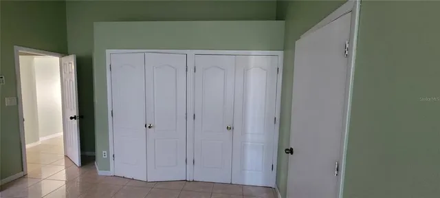 a view of a livingroom with an empty space and a window