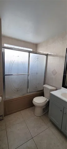 a bathroom with a toilet and a mirror