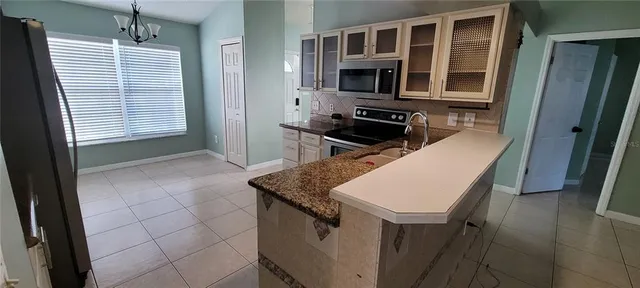 a kitchen that has a stove and a sink