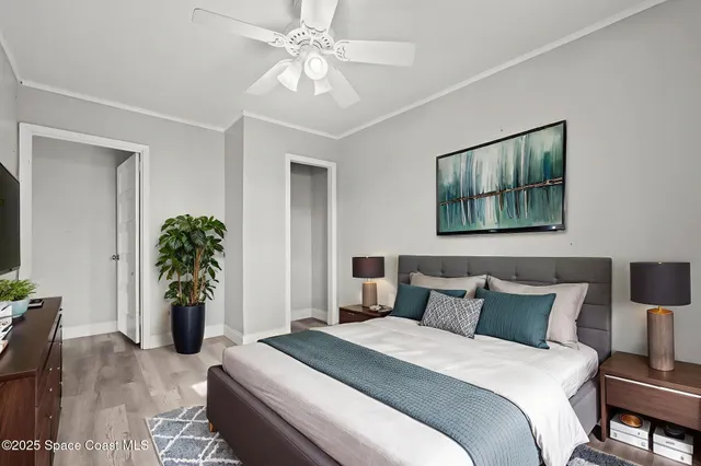 a bedroom with a bed and a potted plant