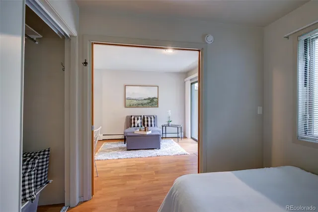 a bedroom with a bed and a painting on the wall